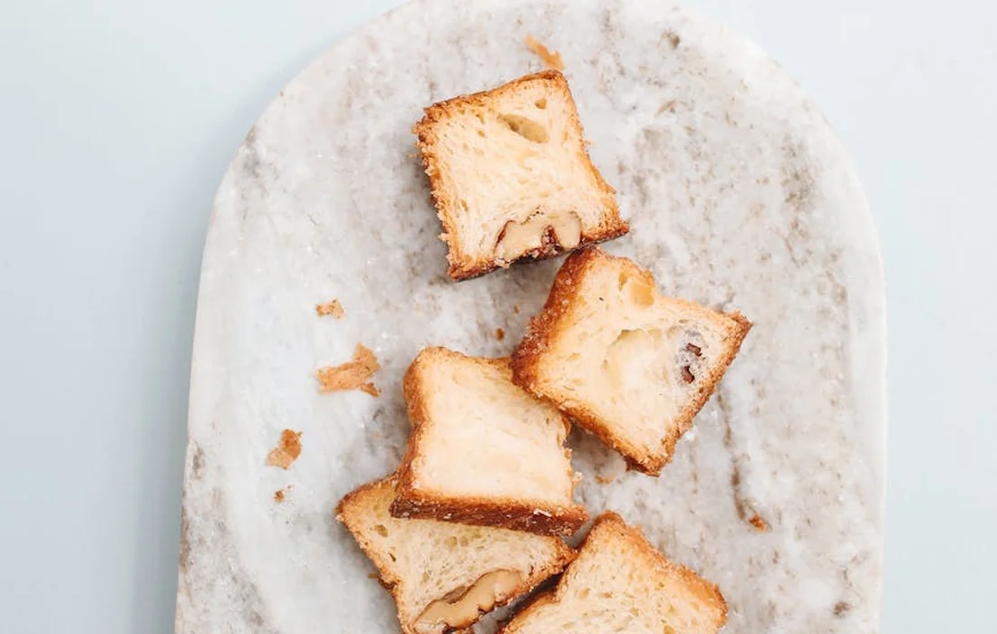 Slices of toasted bread on a light, speckled plate