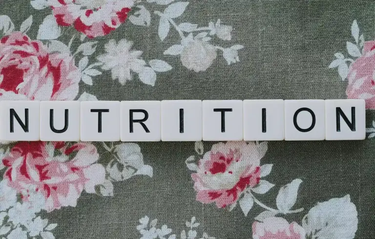 Tiles spelling NUTRITION on a floral fabric background