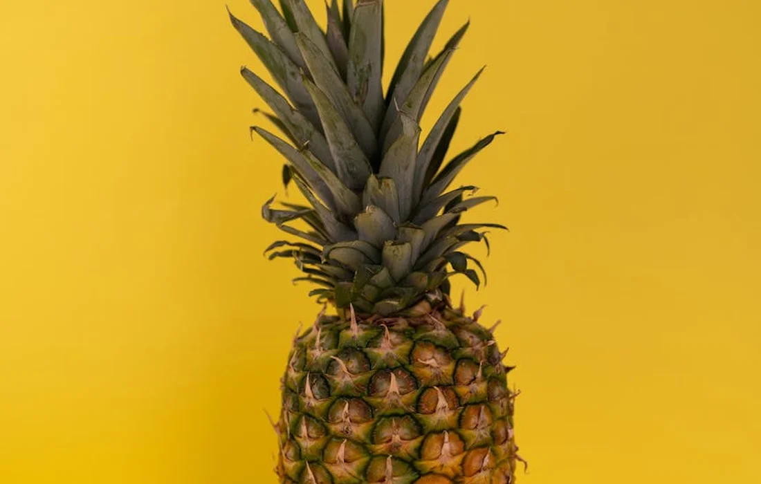 Pineapple against a bright yellow background