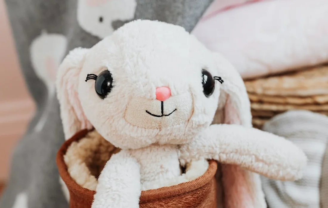 Soft plush bunny toy in a brown pot, close-up