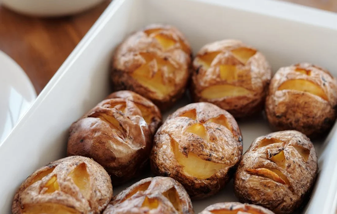 Small roasted potatoes in a white baking dish